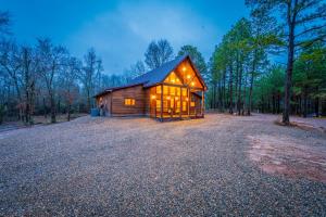 a large wooden cabin in the middle of a forest at The Luxurious Blue Sky Lodge is EPIC! in Broken Bow