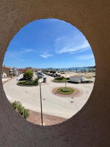 a circular view of a parking lot through a circular window at Apartmani Šaldi in Pakoštane