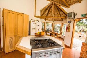 a kitchen with a stove top oven in a room at Chalet Campestre la Peseta in Ubaté