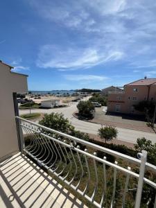 a balcony with a view of a street at Apartmani Šaldi in Pakoštane