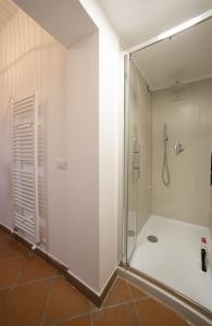 a shower with a glass door in a bathroom at Casa Vacanze L'olivo al Borghettaccio in Assisi