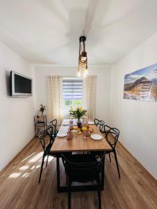 a dining room with a wooden table and chairs at Bieszczadzkie Wyra in Ustrzyki Dolne