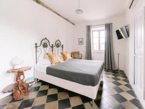 a bedroom with a bed and a checkered floor at Casa Aquadulza in Tremezzo