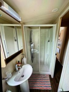 a bathroom with a shower with a sink and a toilet at Relax & Dream in Edinburgh +19 photos