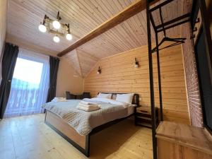 a bedroom with a bed and a wooden ceiling at Kolos house in Slavske