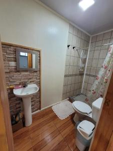 a bathroom with a sink and a toilet and a shower at Hospedaje Alimar in Frutillar