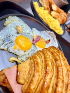 a plate of breakfast food with eggs and bread at St. Gallen Haus in Quito