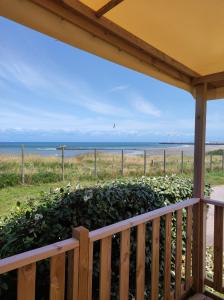 a porch with a view of the beach at Mobil home 2 chambres vue direct sur mer in Le Portel