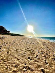 a beach with the sun shining on the sand at Apartamento Isla de Margarita,Porlamar, Pampatar in Porlamar
