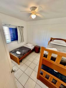 a bedroom with two beds and a ceiling fan at Apartamento Isla de Margarita,Porlamar, Pampatar in Porlamar +32 photos