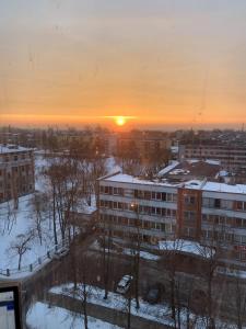 a sunset in a city with snow on the ground at Seaview Flat in Liepāja