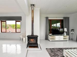 a living room with a fireplace and a tv at Cloud59 in Tygerberg Hills