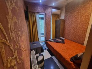 a small room with two beds and a window at Formula1 in Tbilisi City