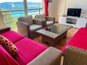 a living room with a couch and chairs and a tv at Villa Tre Tri in Herceg-Novi