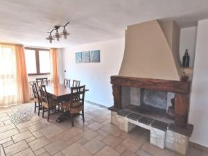 a living room with a fireplace and a table and chairs at Intera casa appena ristrutturata in Parabita