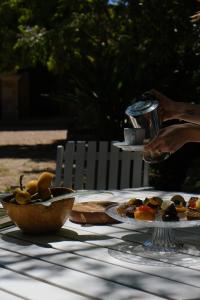 - une table avec un bol de fruits et une assiette de nourriture dans l'établissement casa ventuno, à Tricase
