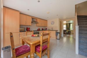 a kitchen with a wooden table and a dining room at 14 Castlegate, Tutbury in Tutbury