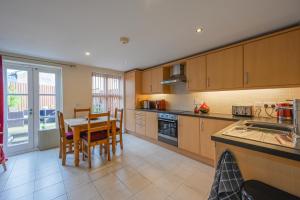 a kitchen with a table and a dining room at 14 Castlegate, Tutbury in Tutbury