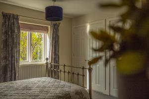 a bedroom with a bed and a window at 14 Castlegate, Tutbury in Tutbury