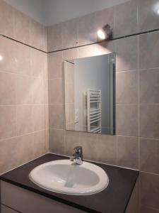 a bathroom with a sink and a mirror at Le créateur - Au coeur de la Ville Haute in Pornic +23 photos