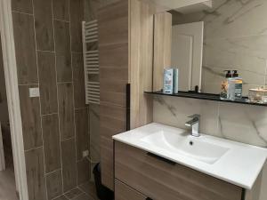 a bathroom with a sink and a shower at La Verdière in Cesny-Bois-Halbout +3 photos