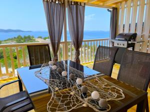 a table with a net on top of a deck at Mobile Home SkyLine - beautiful sea view - on the palm of the beach in Drage