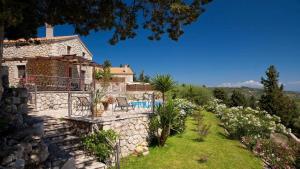 an external view of a house with a swimming pool at Theasis Villas in Lygia