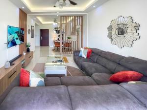 a living room with a couch and a table at Serenity Haven Luxe 2BR, Pool, Wi-Fi, AC, Netflix , DSTV, Gated, Sakumono in Agblesia