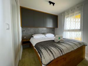 a bedroom with a bed with two towels on it at Mobile Home SkyLine - beautiful sea view - on the palm of the beach in Drage