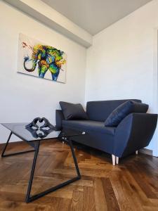 a living room with a blue couch and a table at Salwator Apartment - Topolove Rooms & Apartments in Krakow