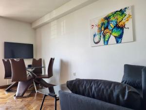 a living room with an elephant painting on the wall at Salwator Apartment - Topolove Rooms & Apartments in Krakow