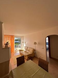 a living room with a couch and a table and chairs at Apartment with Breathtaking view in Praia da Areia Branca
