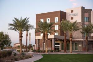 a building with palm trees in front of it at Courtyard by Marriott Mesa at Wrigleyville West in Mesa