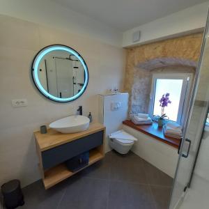 a bathroom with a sink and a mirror at Hidden Heritage in Skradin