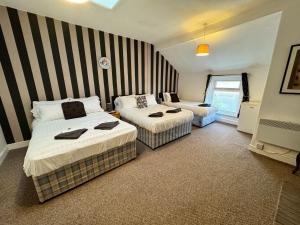 a hotel room with two beds in a room at The Holmlea in Blackpool