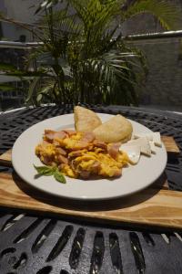 a plate of breakfast food with bacon and toast at Hotel Dorado in Barranquilla