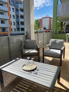 a table and two chairs on a balcony at ApartamentAugust in Zielona Góra