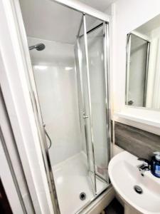 a bathroom with a shower and a sink at Premier Nottingham Studios - Burford Road in Nottingham