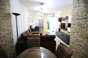 a living room with a couch and a table at Luxury apartment at Panorama Residence Vodno in Skopje