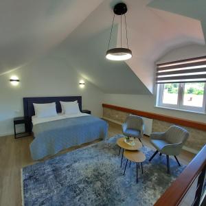 a bedroom with a bed and a table and a chair at Hidden Heritage in Skradin