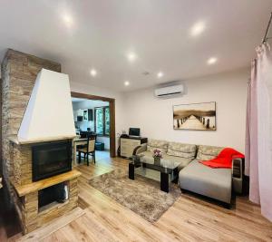 a living room with a couch and a fireplace at Dom na Mazurach in Pilchy