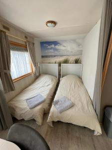 two beds in the back of an rv at Beach House Giethoorn in Wanneperveen