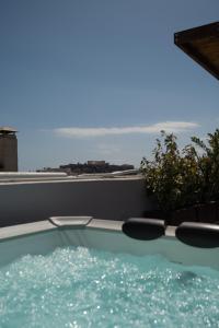 a swimming pool with a view of the ocean at Private Rooftop - Acropolis view - Jacuzzi - Metro in Athens