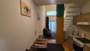 a small kitchen with a table in a room at Cozy Mezonette near City Center Athens near Metro Station in Athens