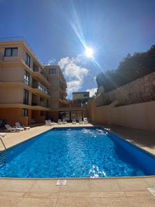 a large swimming pool in front of a building at Apartment with Breathtaking view in Praia da Areia Branca