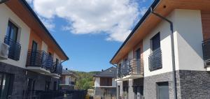 a row of apartment buildings with balconies on them at Apartamenty w Sercu Sosnówki in Sosnówka
