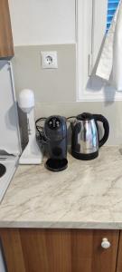 a kitchen counter with a tea pot and a toaster at Φωλιά in Olympos