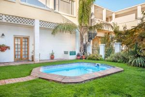 a swimming pool in the yard of a house at Karoo Country Inn in Middelburg