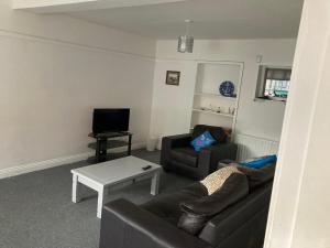 a living room with a couch and a table at Pink door house in Clifden in Clifden