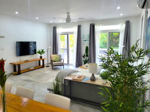 a living room with a table and a tv at CariVenta in Caye Caulker